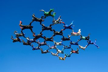 Photo of people in the air constructing a pattern.