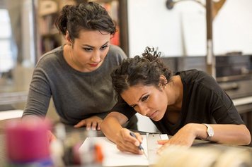 Photo of two working women.
