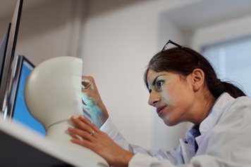Woman working with robot in lab.